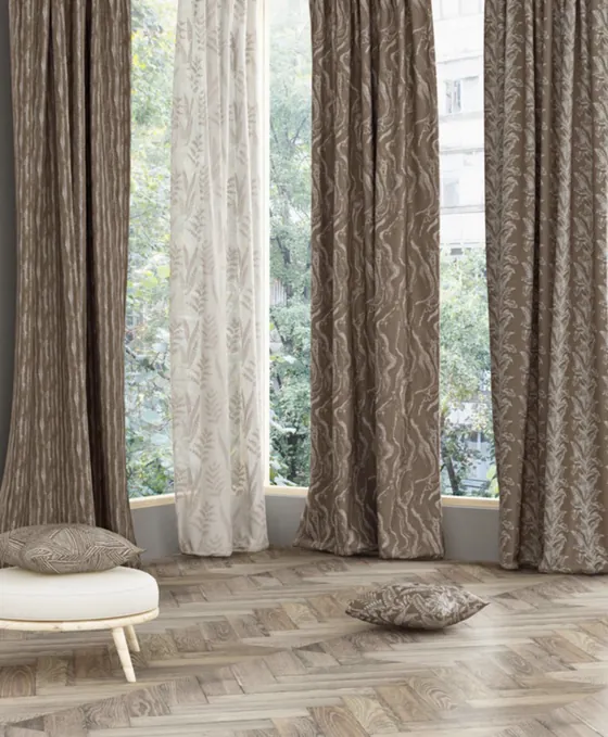 Brown jacquard curtains with a fern sheer at a tall window