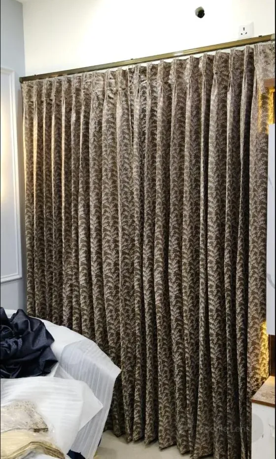 Brown jacquard pinch-pleat curtain in a bedroom