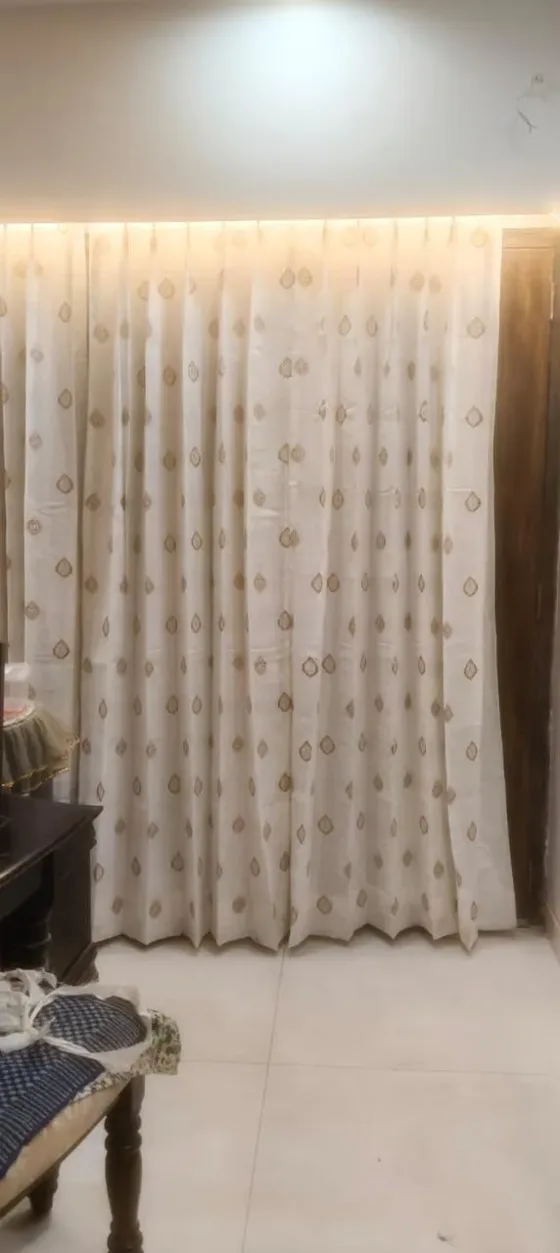Floor-length cream curtain with gold motifs